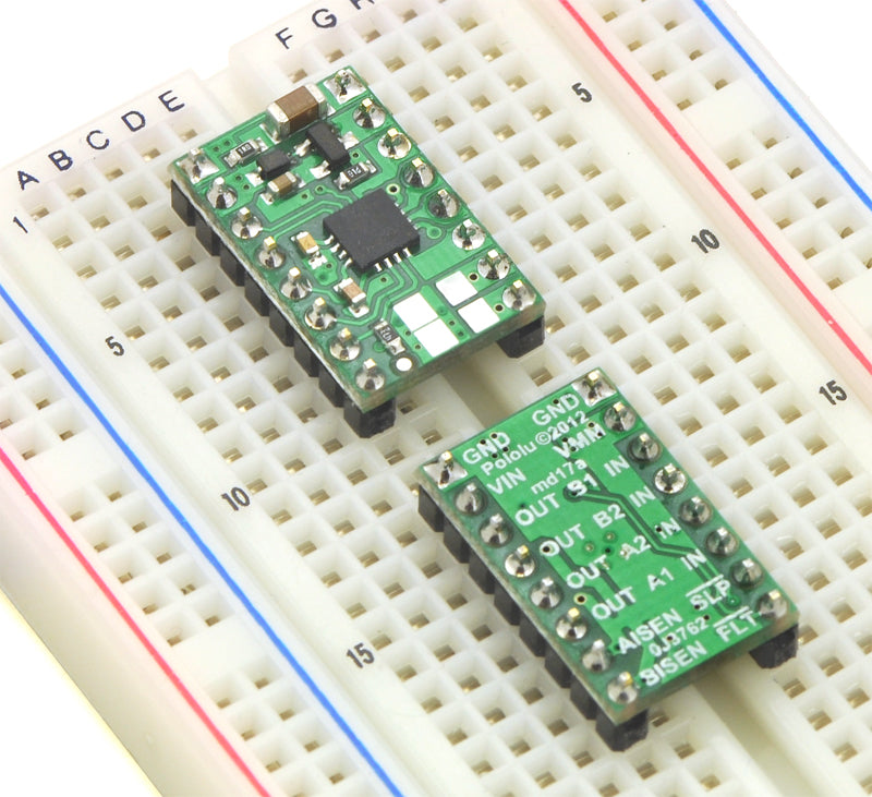 Two DRV8833 dual motor driver carriers plugged into a breadboard.